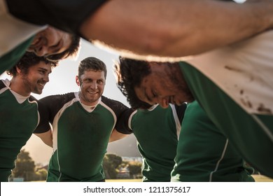 Group of rugby players standing in circle. Professional rugby players in huddle during the game. - Powered by Shutterstock