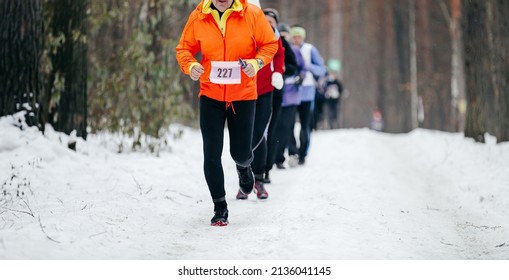 Group Runners Athletes Run Winter Trail Marathon In Forest