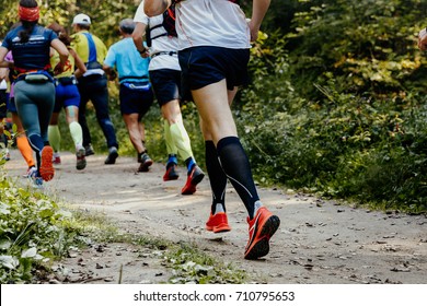 Group Of Runners Athletes Running In Forest Trail Marathon