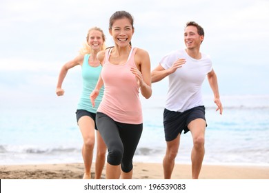 Group Running On Beach Jogging Having Fun Training. Exercising Runners Training Outdoors Living Healthy Active Lifestyle. Multiracial Fitness Runner People Working Out Together Outside Smiling Happy.