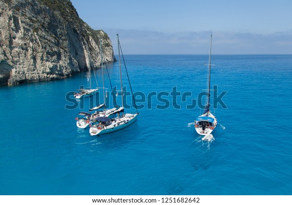 \
A group of\
sailing yachts stand in the\
bay.