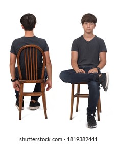 Group Of Same Teenage Boy Sitting  On White Background, Front And Back View And Looking At Camera