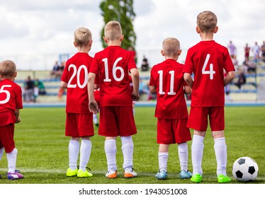 Group Of School Boys On Soccer Game Standing Along Sideline And Watching Competition. Football Tournament For Kids