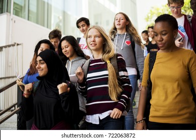 Group of school friends walking down staircase