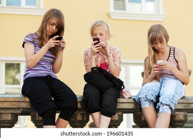 Group Of School Girls Calling On The Cell Phones