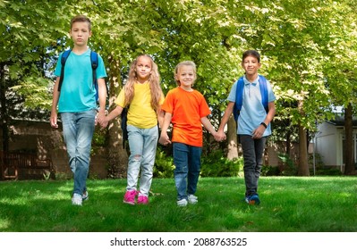 Group Of Schoolchildren Walking Together On The Park