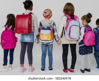 Group Of Schoolers Kids With Backpack Behind Rear View On White Blackground