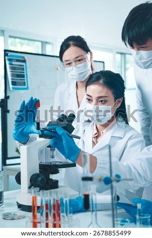 Group of scientists collaborating in a laboratory, engaging in teamwork and planning around experiments, symbolizing cooperation, diversity, and innovation in healthcare and science.