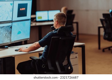 Group of Security data center operators working in a CCTV monitoring room looking on multiple monitors.Officers Monitoring Multiple Screens for Suspicious Activities - Powered by Shutterstock