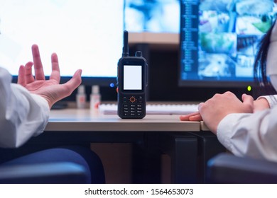 Group of security guards working on computers while sitting in the main control room, CCTV surveillance.