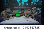 Group of security squad in control center. Military headquarters surveillance officers working in office on laptop with chroma key green screen.