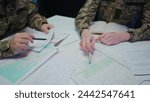 Group of security squad in control center. Military headquarters surveillance officers cyber police briefing at the table in office, close up shot.