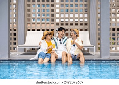 Group of senior Asian family with son hanging out together by swimming pool in the tropical resort hotel for summer vacation travel and happy retirement elder for healthy aging activity wellness - Powered by Shutterstock