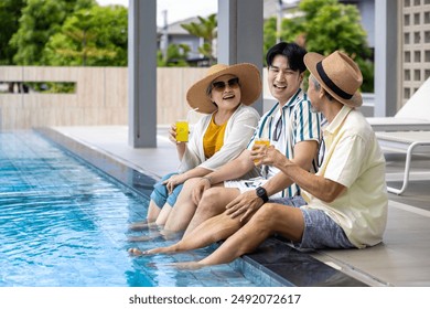 Group of senior Asian family with son hanging out together by swimming pool in the tropical resort hotel for summer vacation travel and happy retirement elder for healthy aging activity wellness - Powered by Shutterstock