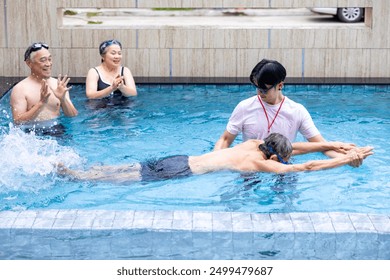 Group of senior asian friend is learning how to swim at the swimming pool with professional trainer for retirement exercise workout activities and healthy wellbeing concept - Powered by Shutterstock