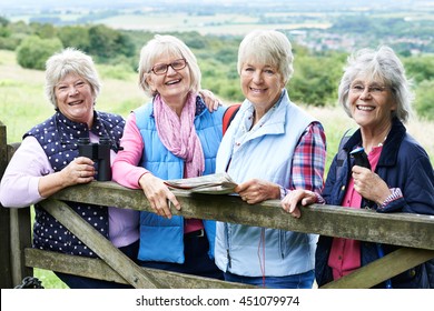 Group Of Senior Female Friends Hiking In Countryside