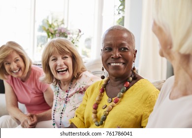 Group Of Senior Female Friends Relaxing On Sofa At Home - Powered by Shutterstock