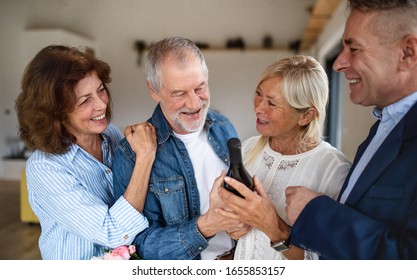 Group of senior friends at dinner party at home, greeting. - Powered by Shutterstock