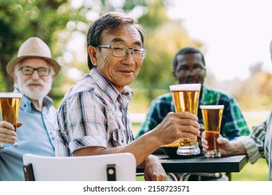 group of senior friends drinking a beer at the park. Lifestyle concepts about seniority and third age
