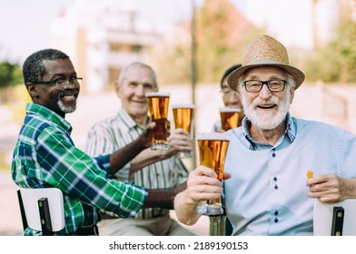 group of senior friends drinking a beer at the park. Lifestyle concepts about seniority and third age