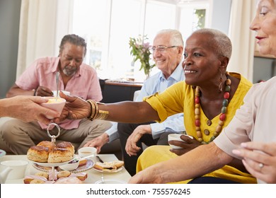 Group Of Senior Friends Enjoying Afternoon Tea At Home Together - Powered by Shutterstock