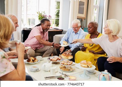 Group Of Senior Friends Enjoying Afternoon Tea At Home Together - Powered by Shutterstock