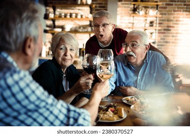 Group of senior friends having a toast in the kitchen at home Caucasian - Powered by Shutterstock