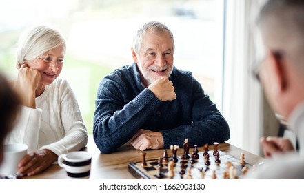 Group Of Senior Friends At Home, Playing Board Games.