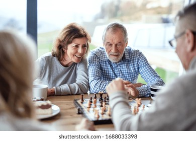 Group Of Senior Friends At Home, Playing Board Games.