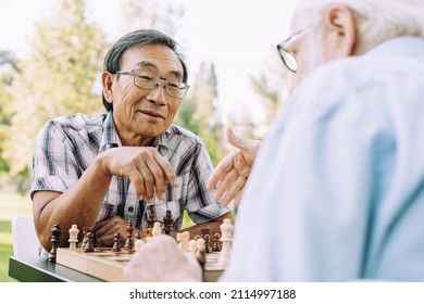 Group of senior friends playing chess game at the park. Lifestyle concepts about seniority and third age - Powered by Shutterstock