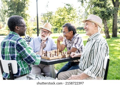 Group of senior friends playing chess game at the park. Lifestyle concepts about seniority and third age - Powered by Shutterstock