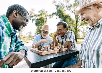 Group of senior friends playing chess game at the park. Lifestyle concepts about seniority and third age - Powered by Shutterstock