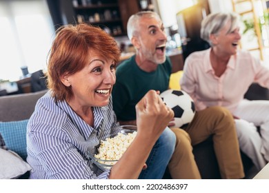 Group Of Senior Friends Support Favorite Sports Team Together 