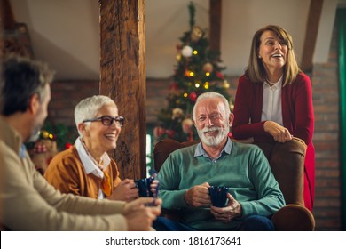 Group of senior friends together at home spending Christmas holidays - Powered by Shutterstock