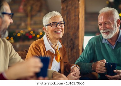 Group of senior friends together at home spending Christmas holidays - Powered by Shutterstock