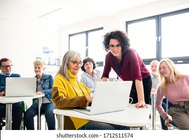 Group Of Senior People Attending Computer And Technology Education Class.