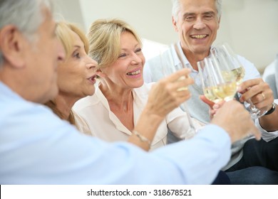 Group Of Senior People Celebrating With Champagne