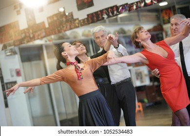 Group of senior people in dancing class with dance teacher - Powered by Shutterstock