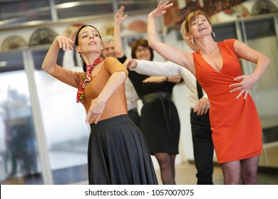 Group of senior people in dancing class with dance teacher - Powered by Shutterstock