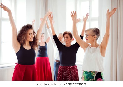 Group Of Senior People In Dancing Class With Dance Teacher.