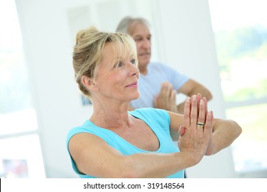 Group Of Senior People Doing Fitness Exercises In Gym