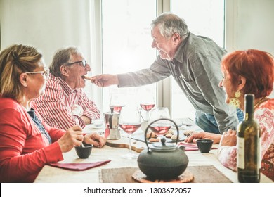 Group Of Senior People Drinking Italian Style Moka Coffee And Tea After Lunch - Mature Happy Friends Eating Biscuits And Laughing Together - Focus On Right Man Face - Joyful Elderly Lifestyle Concept