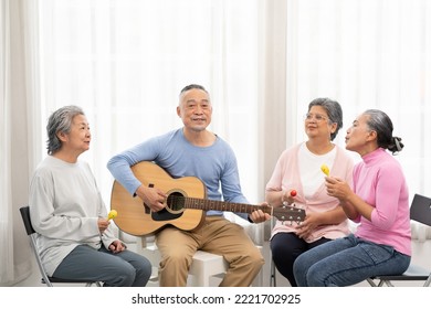 Group Of Senior People Enjoying With Activities Together. Elderly People Having Fun Concept. Happy Senior Playing Guitar And Singing Songs Having Fun Together.