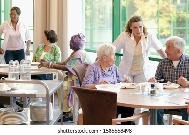 A Group Of Senior People Having Lunch Together In A Retirement Home