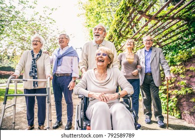 Group Of Senior People With Some Diseases Walking Outdoors - Mature Group Of Friends Spending Time Together