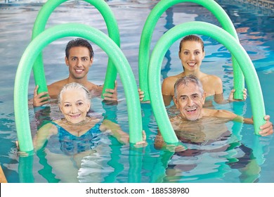 Group of senior people with swim noodles in a swimming pool