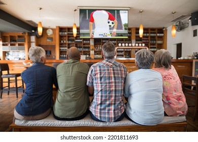 Group Of Senior People Watching Football Match Siting Together In Bar. Sport, Competition And Cheering Together.