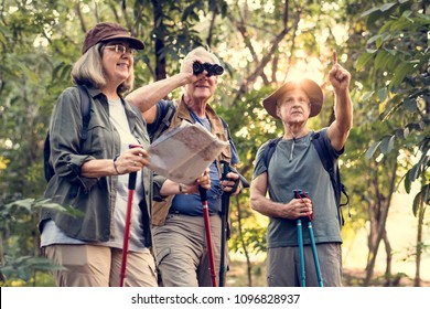 Group of senior trekkers checking a map for direction - Powered by Shutterstock