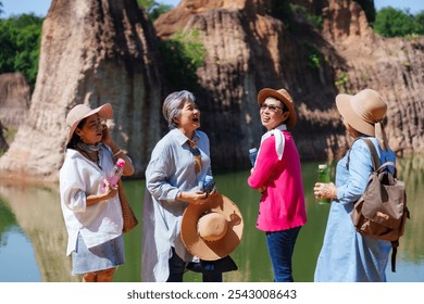 Group of senior women friends smiling and chatting cheerfully during a nature outing, enjoying each other's company in a beautiful outdoor setting, happiness and lifelong friendship in retirement. - Powered by Shutterstock