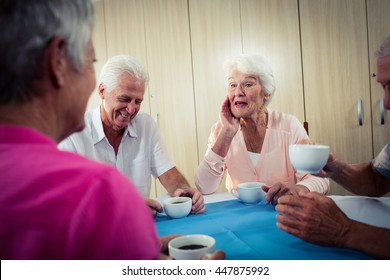 Group Of Seniors Drinking Coffee In The Retirement House